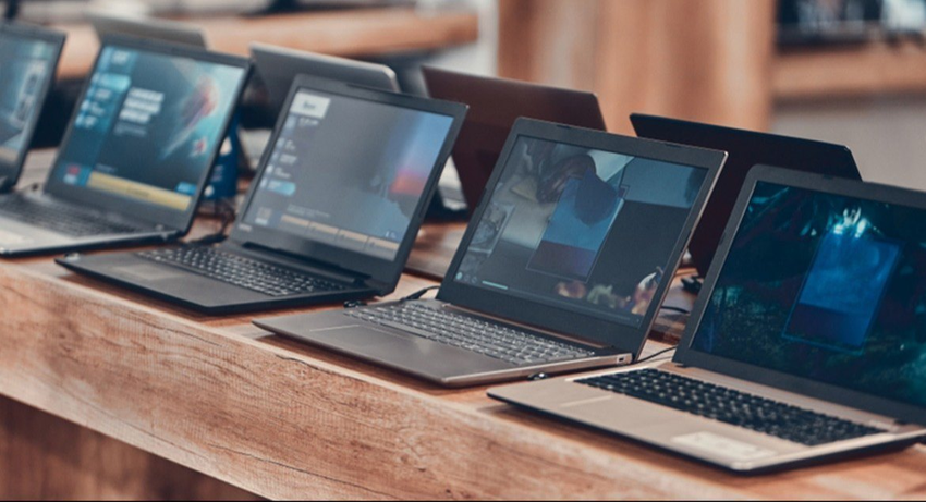 Best refurbished laptop shop in Electronic City Bangalore showing rows of tested second hand laptops for sale.